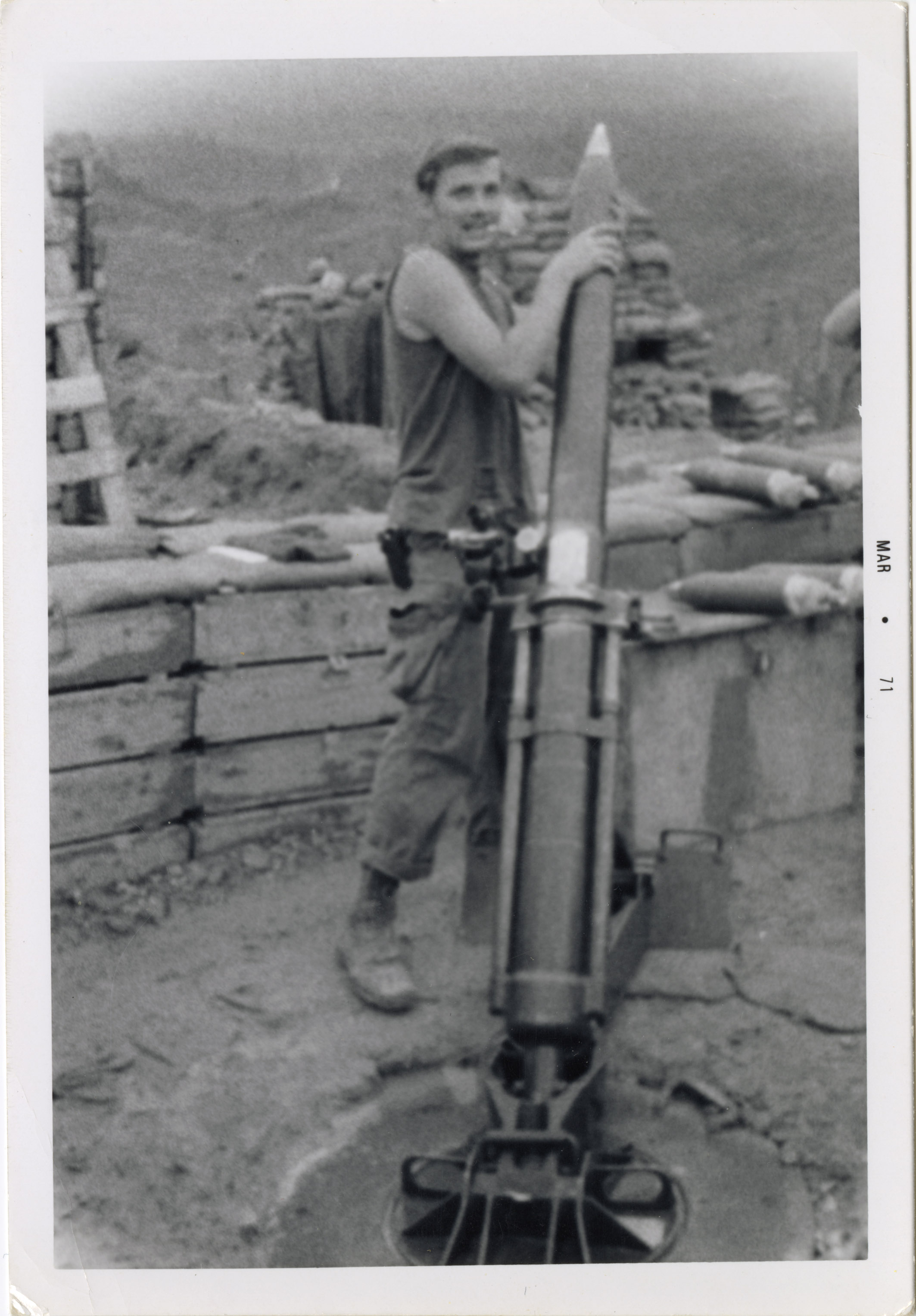 Terry, a soldier in the Vietnam war, is reloading a missile into a missile launcher.