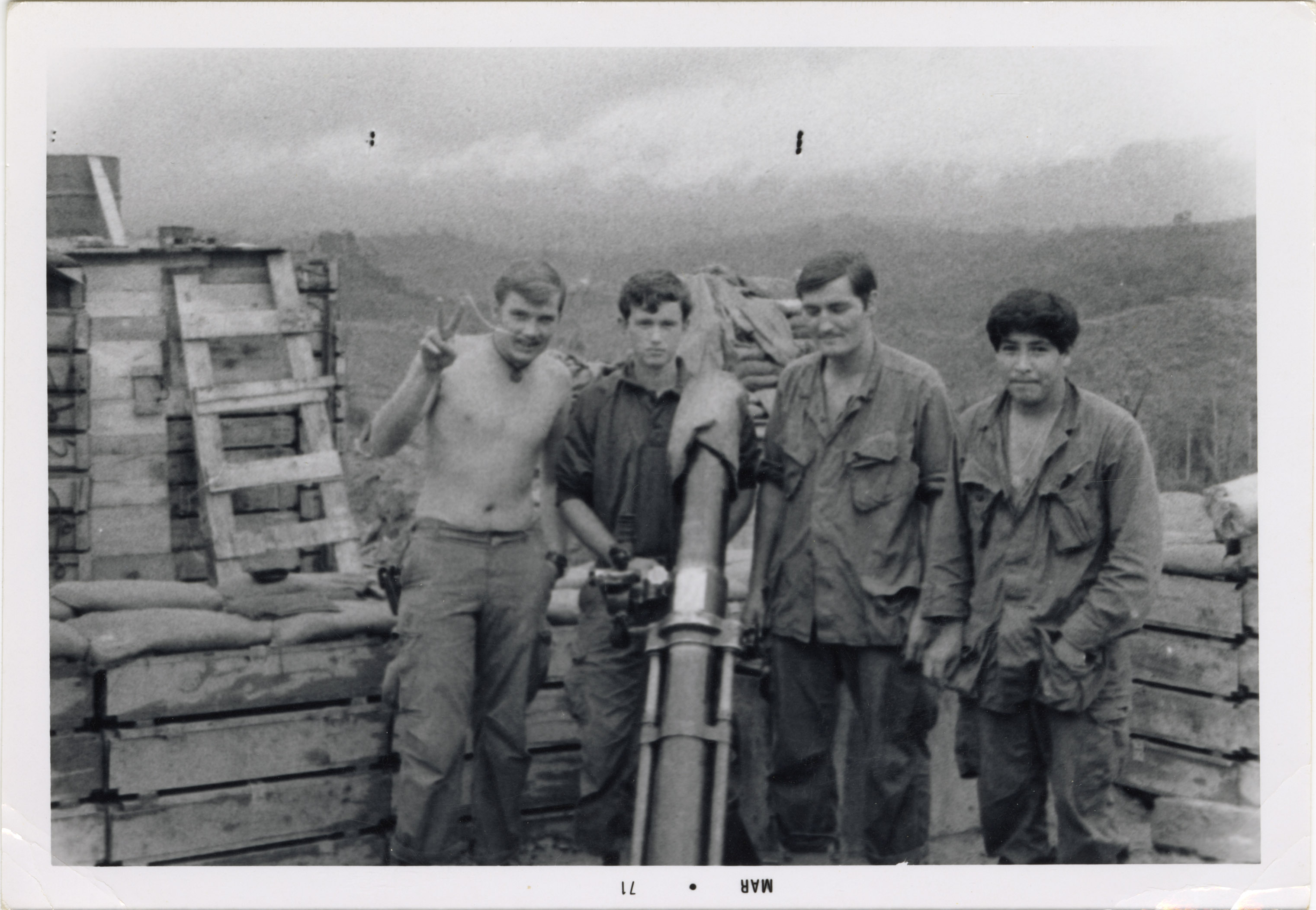 Four soldiers posing for the camera with a missile launcher in between them, with Terry on the left.