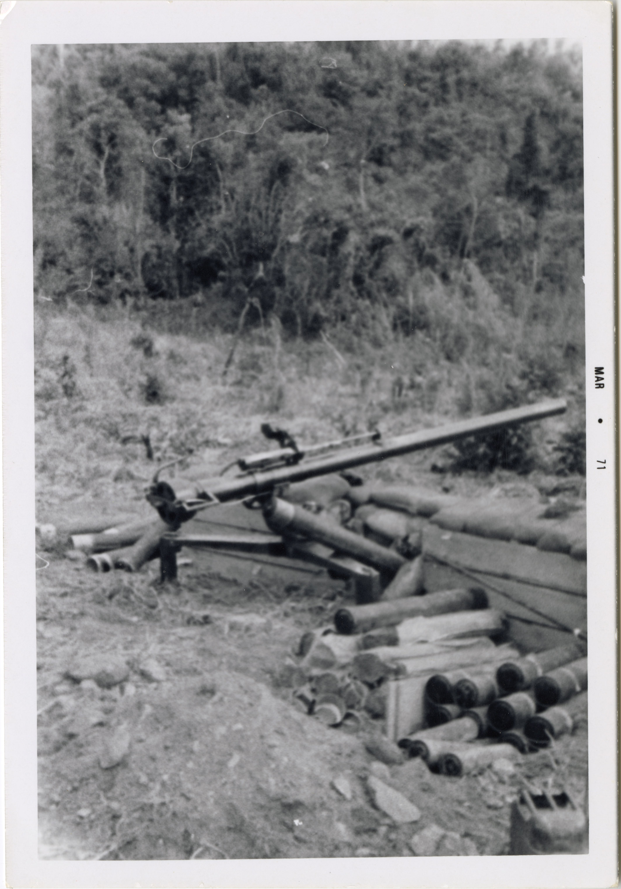 A machine gun is set up on a tripod, ready for firing in case of attack.