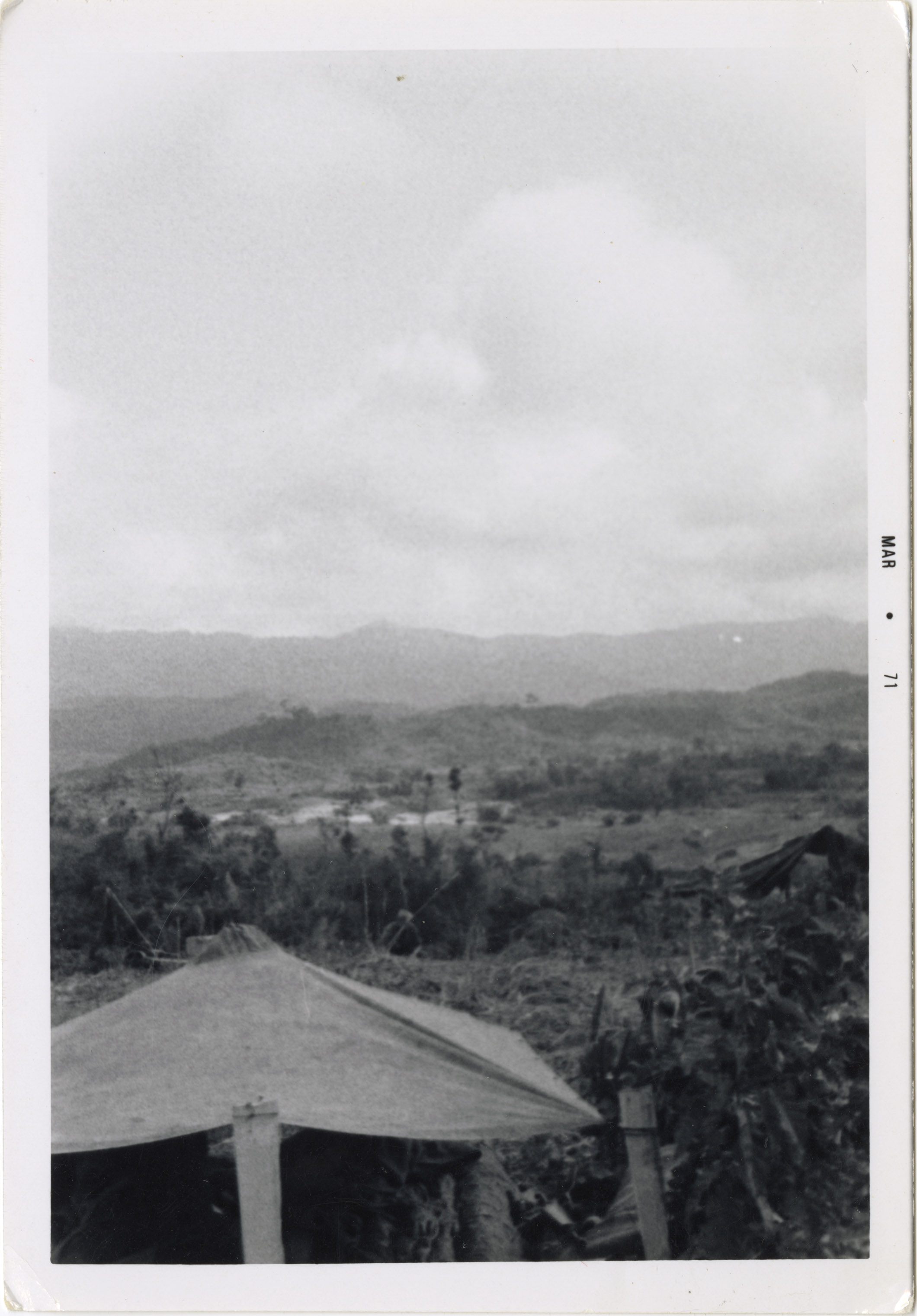 A scenic view of the Vietnamese countryside with mountains in the distance.