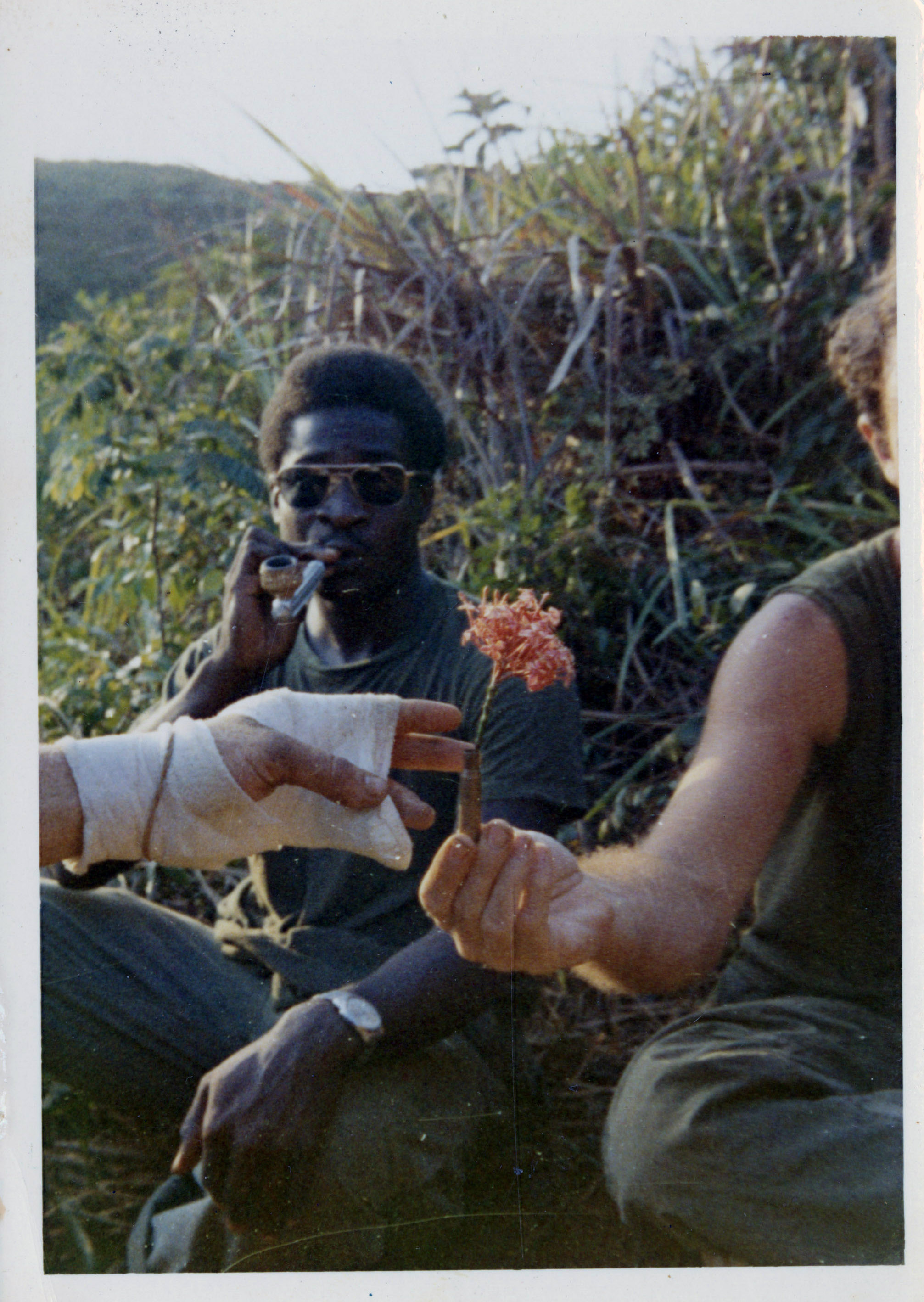 Terry is posing for the camera while leaning against something at the base camp in the Vietnam war.